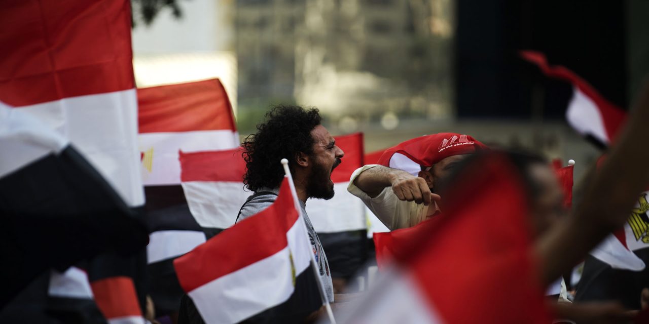 An Egyptian protester shout slogans as demonstrators march through the streets of Cairo on their way to join thousands protesting against President Mohamed Morsi and the Muslim Brotherhood at Tahrir Square on June 30, 2013. Egyptians flooded the streets determined to oust Morsi on the anniversary of his turbulent first year in power, in the biggest protests Egypt has seen since the 2011 revolt. AFP PHOTO/GIANLUIGI GUERCIA        (Photo credit should read GIANLUIGI GUERCIA/AFP/Getty Images)